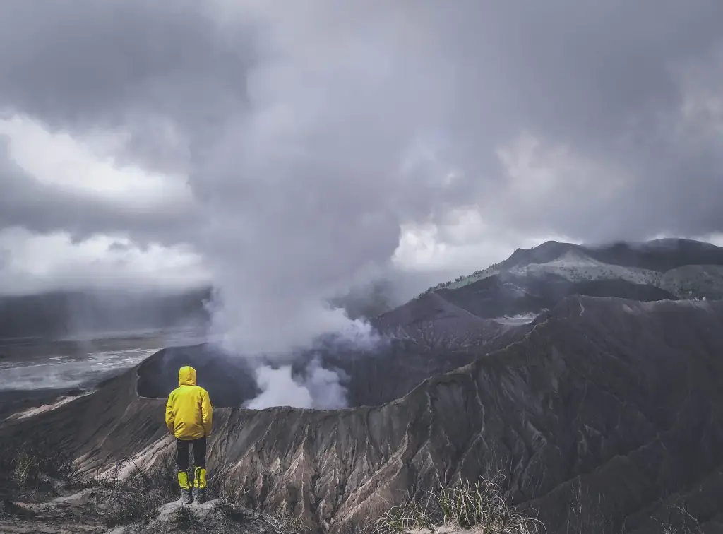 A person standing on a volcano.