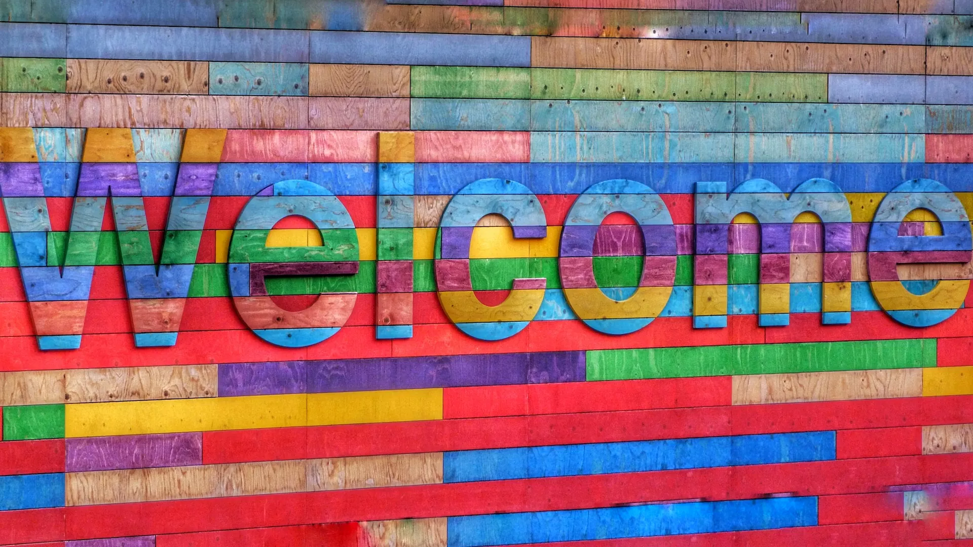 A vibrant sign displays a warm welcome.