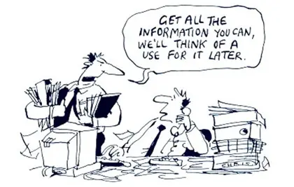Cartoon of an office shows one person at a cluttered desk on the phone and another handing over some files. 